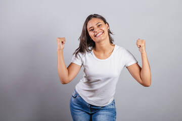 beautiful brazilian woman. denim and white. smiling, dancing. optimistic, very happy.