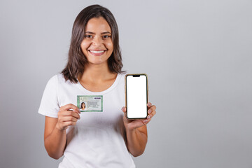 Brazilian woman, with Brazilian identity card, RG, document. Smartphone, white screen for...