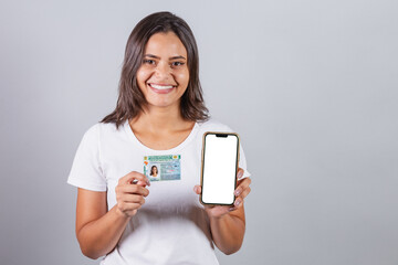 Brazilian woman, with driver's license, CNH, document. Smartphone, white screen for advertisements.