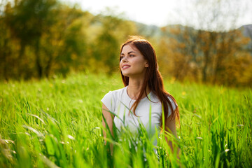 happy cheerful woman laying in green grass