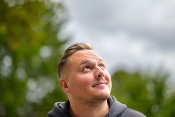 Young man looks up at the sky