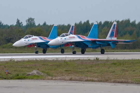 KUBINKA, RUSSIA - AUGUST 20, 2022: Two Russian Su-35S fighters of the Russian Knights aerobatic team before takeoff on a gloomy summer day. Kubinka airfield