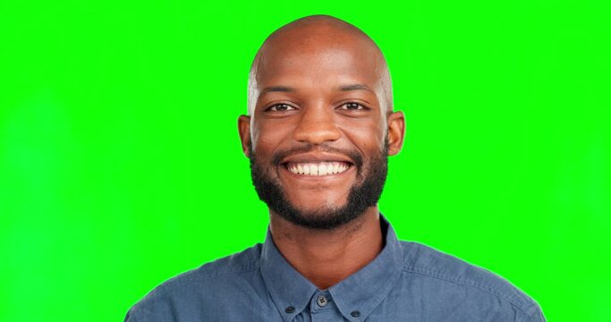 Face, smile and a black man on a green screen background in studio looking carefree or positive. Portrait, wink and happy with a bald male on chromakey mockup feeling cheerful about product placement