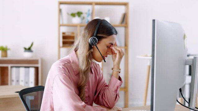 Tired business woman, call center and headache in stress, burnout or talking to difficult client in customer service at office. Exhausted and frustrated female consultant or agent annoyed on computer