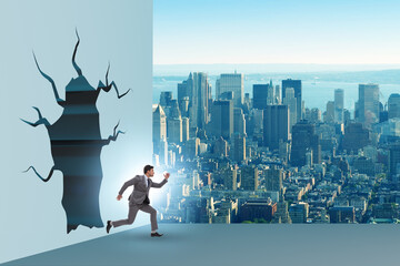 Businessman breaking through the wall