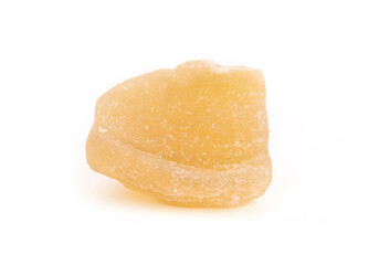 Isolated candied ginger piece, close up. Yellow chunk of candied or crystallized ginger. Healthy...