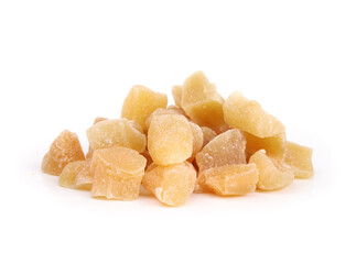 Isolated candied ginger pieces in a pile. Many yellow chunks of candied or crystallized ginger. Healthy snack for helping with digestive system, motion sickness and immunize system. Selective focus.