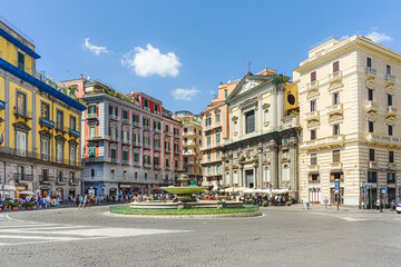 Fototapeta na wymiar Naples, Italy. View of Piazza Trieste e Trento on a sunny August day. In the foreground, the so-called Artichoke Fountain. On the background the San Ferdinando Curch. 2022-08-20.