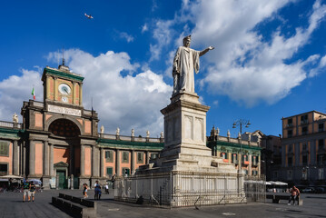 Fototapeta na wymiar Naples, Italy. View of Piazza Dante with the Dante Alighieri's statue and the facade of the building of the ancient Convitto Nazionale Vittorio Emanuele School. 2022-08-20.