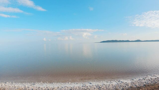 4K shot of salt lake with reflection of sky in water at Dholavrira, Kutch, India. Tranquil Nature landscape. Salt lake blue sky with clouds in Kutch. 