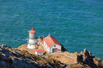 Fototapeta na wymiar Point Reyes Lighthouse on rocky cliff over Pacific Ocean in California