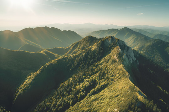 Beautiful sunrise over the green mountains in morning light with fluffy clouds on a bright blue sky. Nature freshness concept
