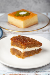 Güllaç, revani, tulumba and bread kadayif dessert with cream on a wood floor. Ramadan sweets. Traditional Turkish cuisine delicacies