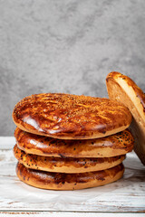 Sesame ramadan pita on a wood floor. Ramadan delicacies. Pita bread special for the month of Ramadan. Local name pastane pidesi. Close up
