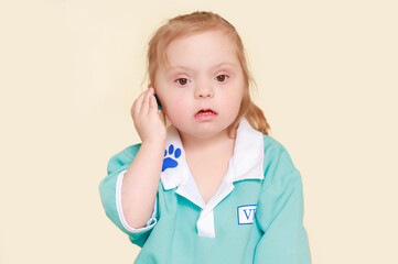 Close-up portrait of a girl with Down syndrome. Child in blue clothes.
