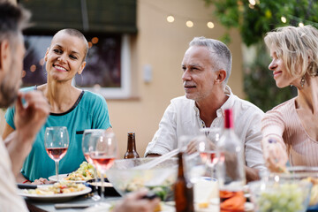 Conversation around the table - Family friends dinner in summer