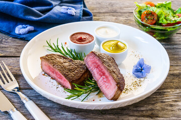 Fried beef sirloin on wooden table
