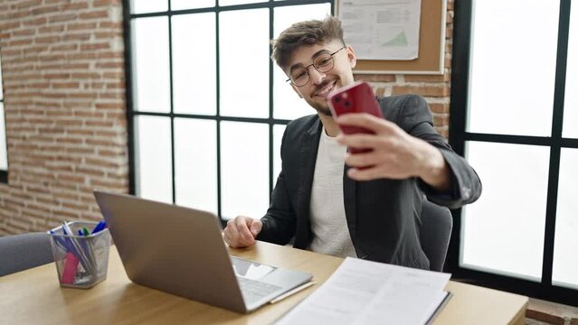 Young arab man business worker make selfie by smartphone working at office