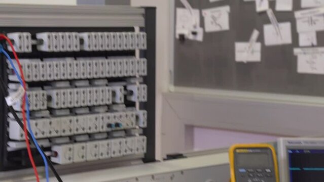 electrician apprentice working with patch bay and different tools