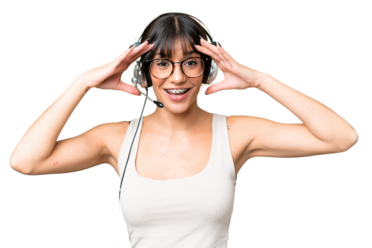Telemarketer caucasian woman working with a headset over isolated background with surprise expression