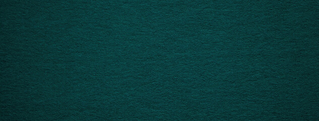 Texture of old dark green paper background, macro. Structure of a vintage craft teal cardboard....