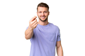 Young handsome caucasian man over isolated chroma key background making money gesture