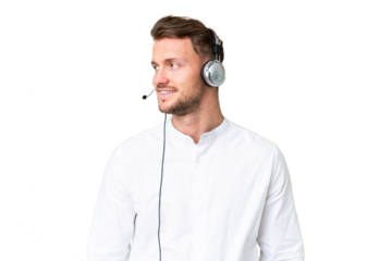 Telemarketer caucasian man working with a headset over isolated chroma key background looking side