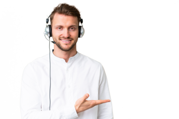 Telemarketer caucasian man working with a headset over isolated chroma key background presenting an idea while looking smiling towards