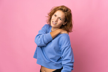Fototapeta premium Young Georgian woman isolated on pink background suffering from pain in shoulder for having made an effort