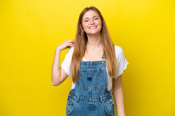 Young caucasian woman isolated on yellow background laughing