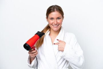 Young caucasian woman holding hairdryer isolated on white background with surprise facial expression