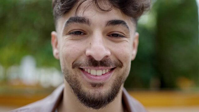 Young arab man smiling confident standing at park