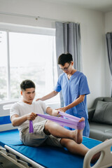 Fototapeta premium Physiotherapist Helping Patient While Stretching His Leg in bed