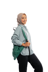 Fototapeta premium smiling Asian Muslim girl in hijab walking pose with backpack on isolated background