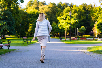 Beautiful woman walking in city park
