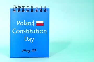 Constitution Day of Poland reminder on blue desk calendar with flag icon. Celebration concept