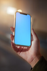 Closeup, hands or smartphone green screen for woman on social media app, night research or internet mockup branding. Blue, mock up or technology for working late person on business product placement