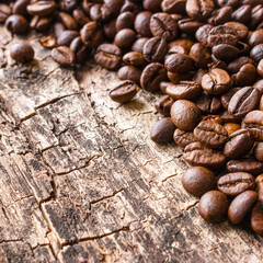 roasted coffee beans on a wooden background close up