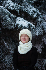 Fototapeta na wymiar Beautiful girl on the street in winter in a white hat