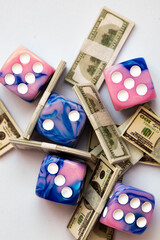 two purple dices on US 100 dollar banknotes background