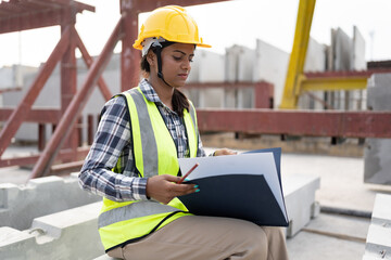 India engineer woman working with document at precast site work	
