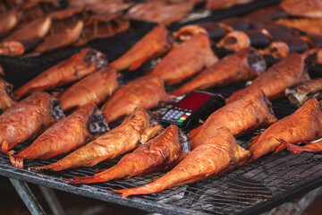 Selling various smoked fish in a street food market in Vilnius, Lithuania, Europe, close up