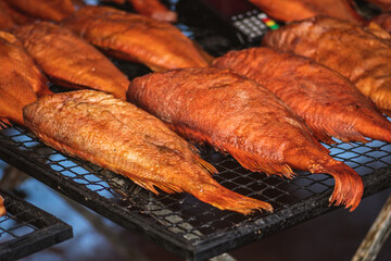 Selling various smoked fish in a street food market in Vilnius, Lithuania, Europe, close up