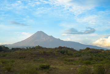 Colima Volcano; Mexican landscape with blue sky and clouds.