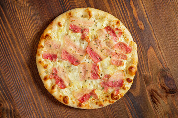 pizza with bacon on the wooden background
