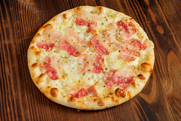 pizza with bacon on the wooden background