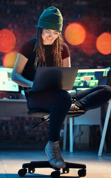 Laptop, woman and hacker typing in home for programming, software or cybersecurity. Smile, computer and happy female coder or it programmer with ransomware for hacking while on dark web at night.