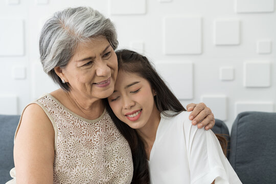 Close up happy Asian old mature female embracing young grownup with kindly. Young woman carefully takes care of senior elderly grandma. Old grandmother hugging young daughter with happy, smiling