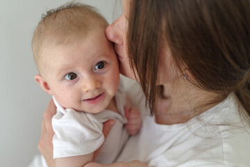 Mother embracing baby boy 3 months
