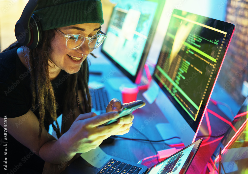 Poster Woman, phone texting and computer programmer in home for streaming radio or podcast in neon. Hacker, music headphones or happy female coder with mobile for sound, audio or typing on dark web at night